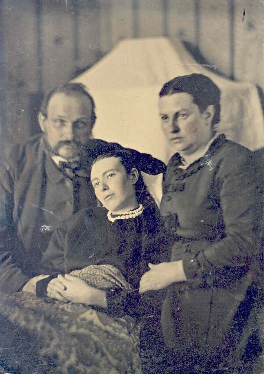 Victorian_era_post-mortem_family_portrait_of_parents_with_their_deceased_daughter.jpg